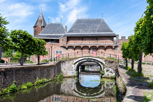 View over Eem canal towards the medieval gate Koppelpoort in Amersfoort, the Netherlands that combines land and water-gates and is part of the second city constructed between 1380 and 1450