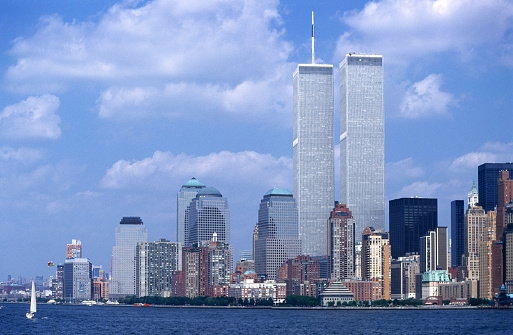 Amidst an azure canvas, the Twin Towers stood as icons in Manhattan's skyline, symbolizing architectural and economic prominence. This evocative scene, a remnant of an altered cityscape, carries poignant memories, signifying a changed era in urban history.