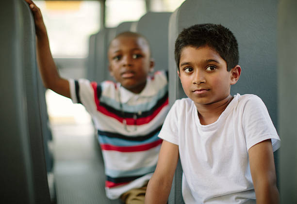 istock children sitting on school bus 155598319