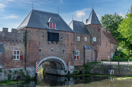 View over Eem canal towards the medieval gate Koppelpoort in Amersfoort, the Netherlands that combines land and water-gates and is part of the second city constructed between 1380 and 1450