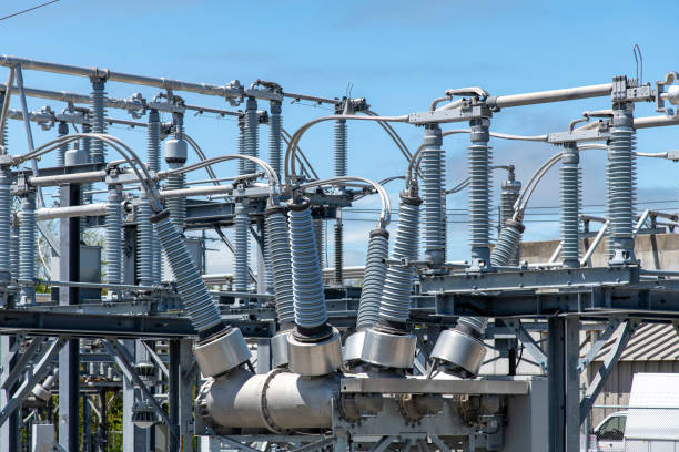 High-voltage bushings on a utility transformer at an electrical substation Close up view of some high-voltage bushings on a utility transformer at an electrical substation which allows an electrical conductor to pass safely through a conducting barrier transformer stock pictures, royalty-free photos & images