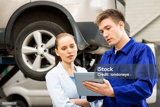 Mechanic With Customer Using Digital Tablet Stock Photo - Download Image Now - Mechanic, Customer, Auto Repair Shop