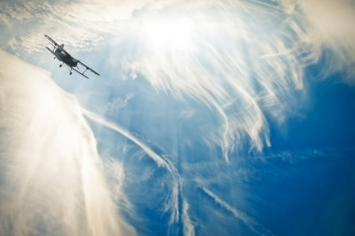 biplane between impressive cloud formation