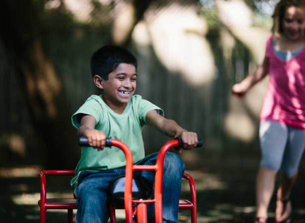 istock boy ridding a tricycle 155599517