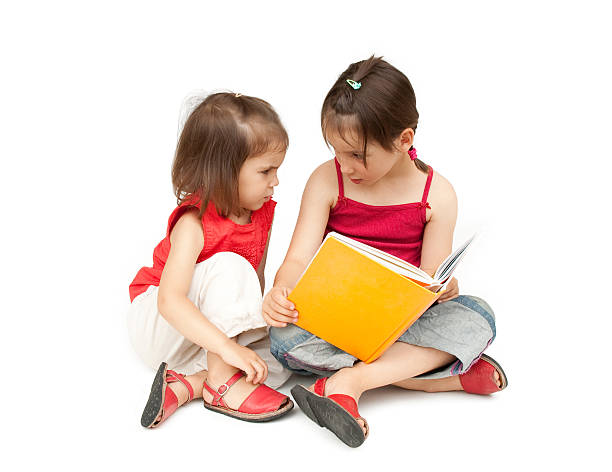 istock little girls reading a book 155599564