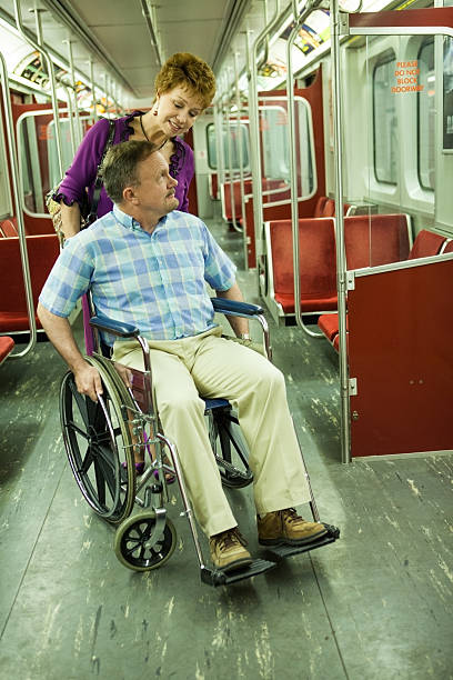 istock Woman helping man in a wheelchair 155599607