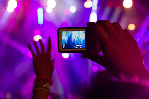 istock Shooting with cell phone a music event 155599760
