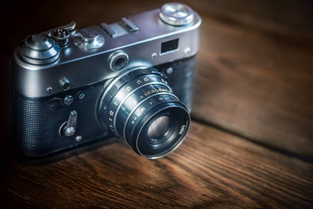 istock Vintage photo camera on old wooden table 155600005