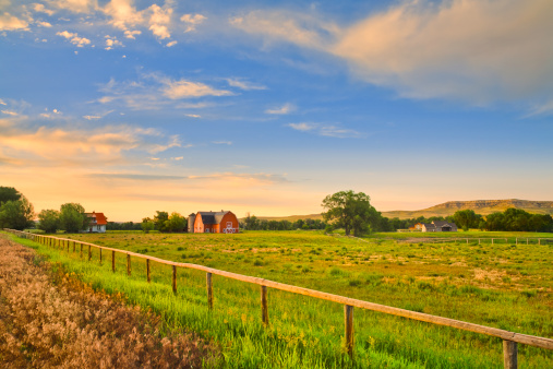 countryside with farm buildings at sunset in rural Montana