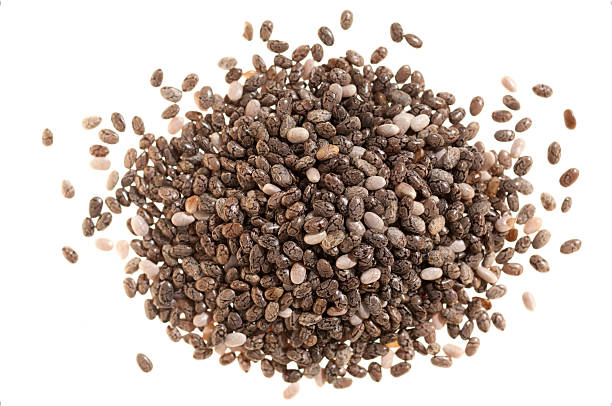 Pile of chia seeds on white A pile of chia seeds, isolated on white. chia seed photos stock pictures, royalty-free photos & images