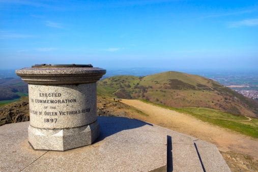 The toposcope and memorial on Worcestershire Beacon in hazy spring sunshine, the highest point on the Malvern Hills , Worcestershire, UK