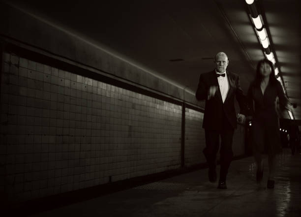 istock elegant couple running 155600964