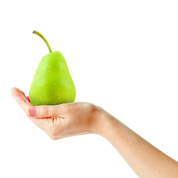 female hand holding fresh pear