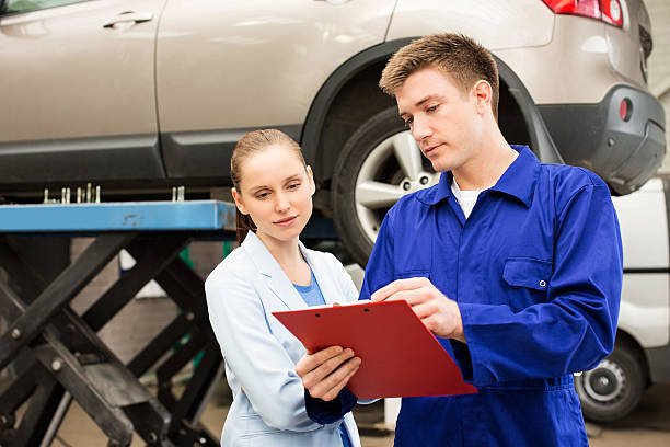 istock Mechanic Explaining Expenses To Female 155601141