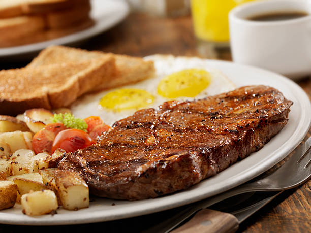 Steak and Eggs Grilled Rib Eye Steak with Sunny-side up Eggs, Hash Browns, Grilled Tomatoes and Toast -Photographed on Hasselblad H3D2-39mb Camera hash brown stock pictures, royalty-free photos & images