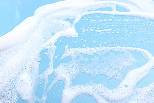 foam on blue motorhood background - schuim stockfoto's en -beelden