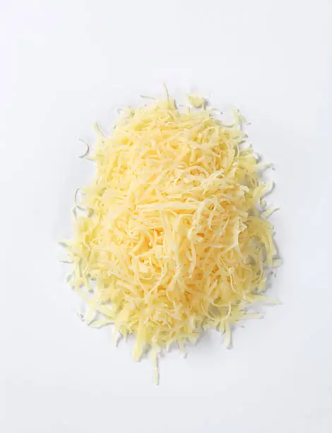 Heap of grated cheese isolated on white