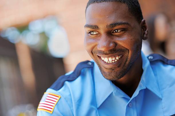 Happy American Security Officer An American security or police officer smiling and happy. police force smiling officer stock pictures, royalty-free photos & images
