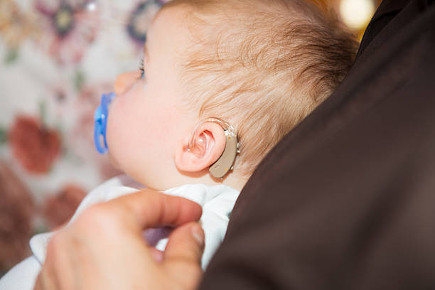 Cute baby boy wearing hearing aid