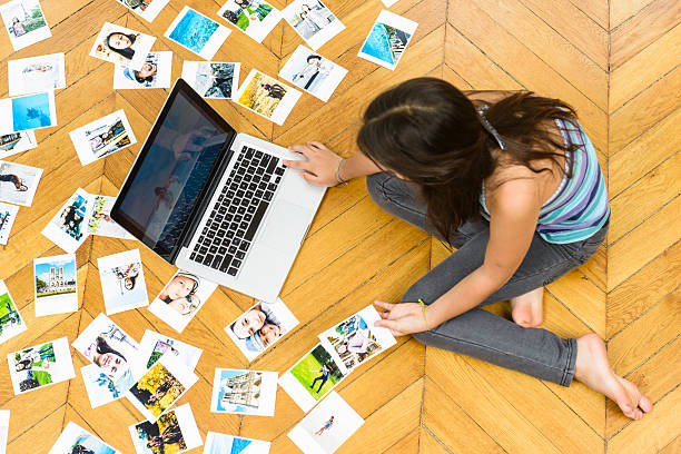 Printing memories Young girl is sorting and printing her vacation pictures printing out photos stock pictures, royalty-free photos & images