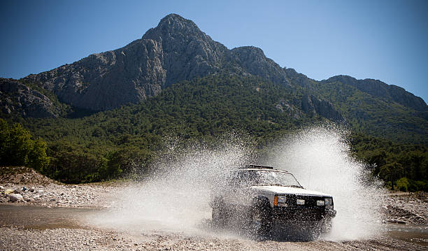 jeep, throwing the water stream passing through stock photo