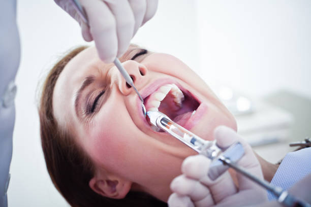 istock Painful Dental Procedure with Injection Needle 155602714