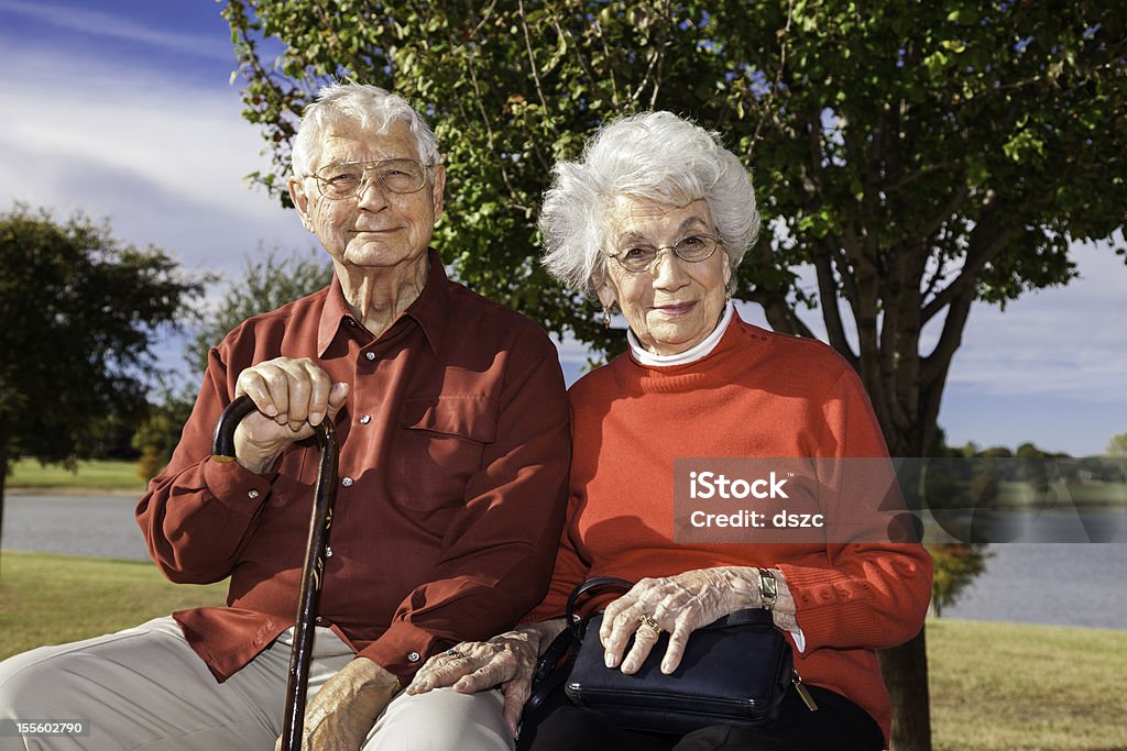senior couple outside in park senior couple outside in park on early autumn day Senior Couple Stock Photo