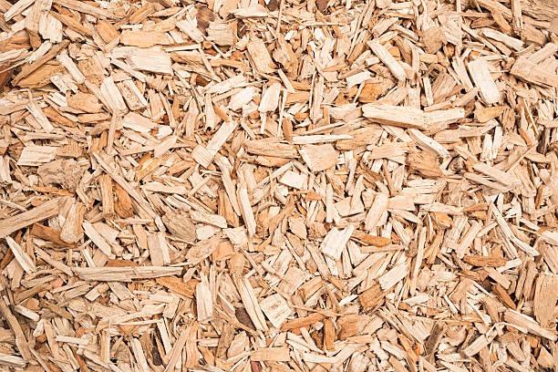 Wood Chip Fuel for Biomass Boiler A background of wood chips, prepared as fuel for a biomass boiler. recyclable materials stock pictures, royalty-free photos & images