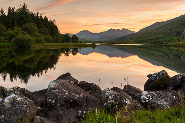 Snowdon Mountains at Llyn Mymbyr The mountains of Snowdonia reflected at sunset in Llyn Mymbyr in the Snowdonia National Park, Wales, UK. snowdonia national park stock pictures, royalty-free photos & images