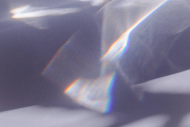 istock Sunlight background, abstract photo with light and shadow, glare and shine on paper texture, rainbow flare from sun, gray blue minimal aesthetic fon. Natural light and caustic effects. 1556030607