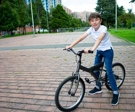 A young American boy child riding bicycle or bike.