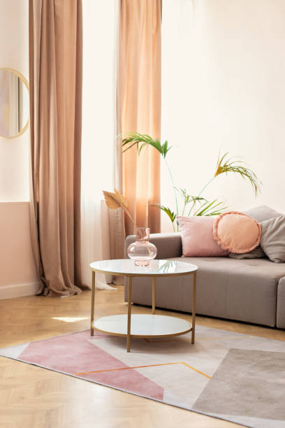 istock Cozy living room interior design with stylish grey sofa, pillows and coffee table with bouquet of dried flowers in modern scandinavian home. Modern room interior with comfortable sofa and furniture 1556036268