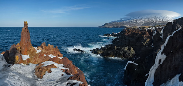 Russia. Far East, Kuril Islands. Very hard and sharp basalt rocks along the coast of the Sea of Okhotsk on the island of Iturup.