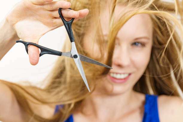 istock Woman with scissors ready to hair cutting 1556053856