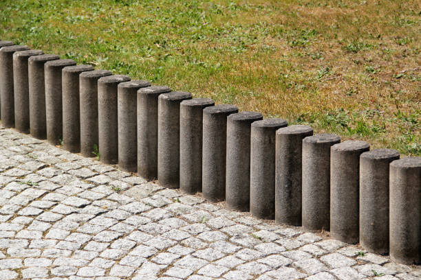 istock Concrete kerb between lawn and cobbled sidewalk in a park 1556054384