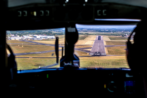 An aircraft landing or taking off from an airport tarmac runway.