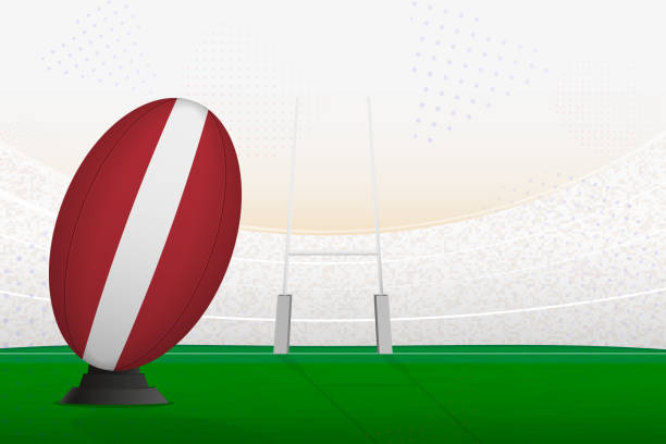 istock Latvia national team rugby ball on rugby stadium and goal posts, preparing for a penalty or free kick. 1556067708
