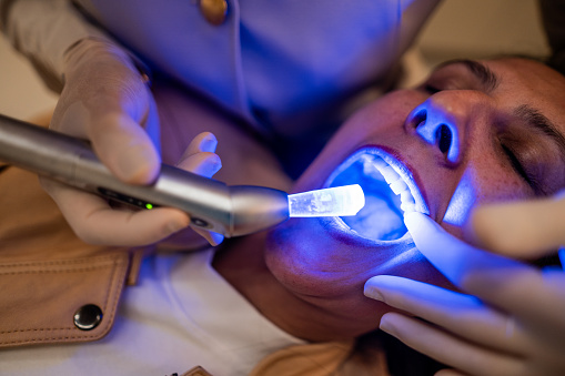 Patient during a tooth whitening at dentist's clinic
