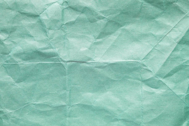 istock Green crumpled kraft background paper texture 1556113396