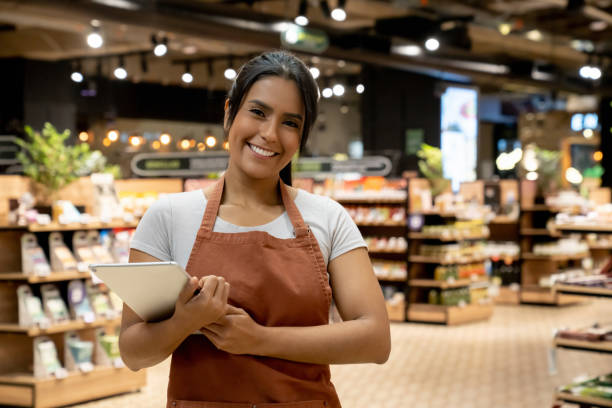 istock Happy retail clerk working at a supermarket 1556119814