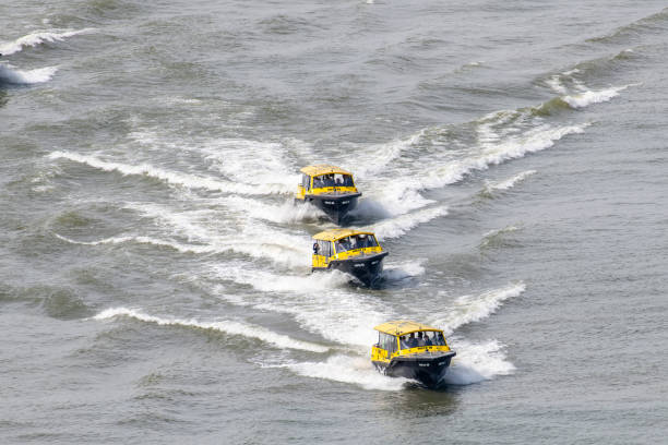 Rotterdam, the Netherlands-April 27, 2023; High angle view of three water taxi’s in line on the Maas river at high speed leaving a wake behind