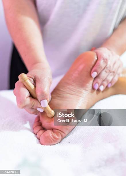 Masseur Doing A Reflexology Foot Massage In A Spa Stock Photo - Download Image Now - 30-34 Years, Adult, Adults Only