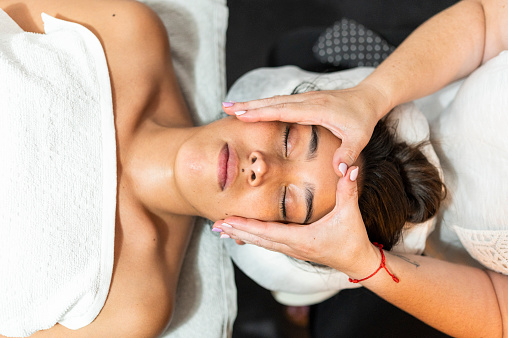 Top view of a woman getting a spa treatment face massage