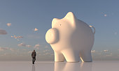 Businessman looking at giant piggy bank