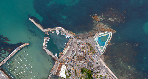 Aerial view directly above The Jubilee outdoor swimming pool and harbour on the rocky coastline of Penzance in Cornwall in a map style