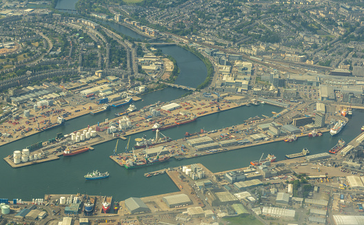 A large British harbour / port to allow ships to be anchored or to come in and drop off or load goods to be distributed across the world.