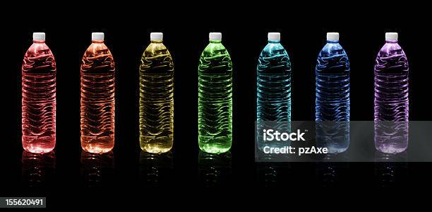 Bottles Of Drinking Water Rainbow Colors On A Black Stock Photo - Download Image Now