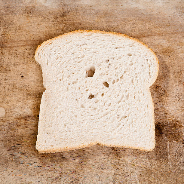 istock slice of bread on wood 155623026
