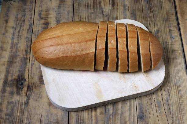 istock A loaf of bread is cut into pieces on a cutting board. 1556241334