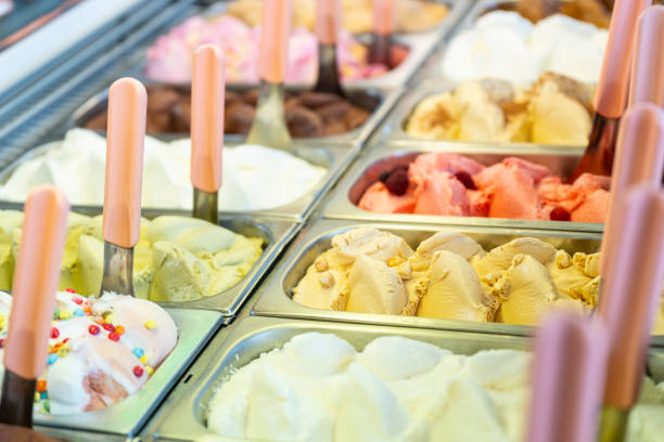 istock Ice cream display case with lots of trays with different flavors 1556248252
